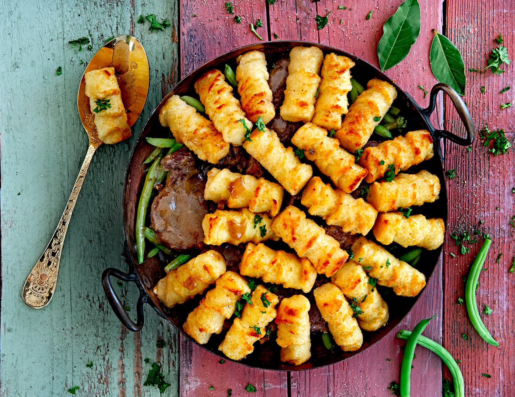Laurel stew with green beans and potato croquette topping